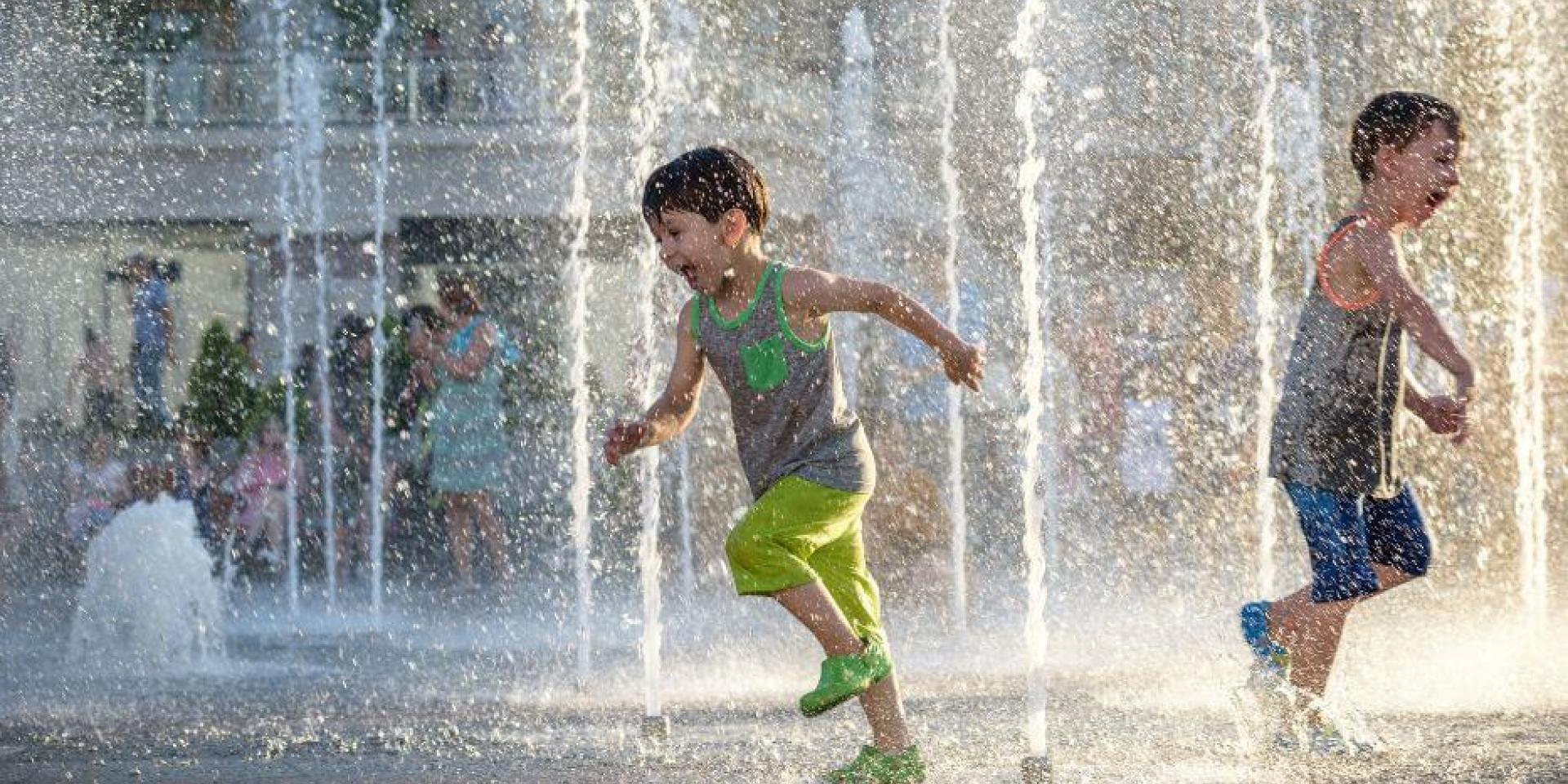 child running through fountain