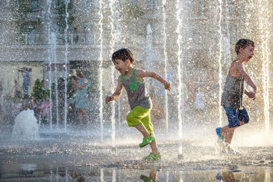 child running through fountain